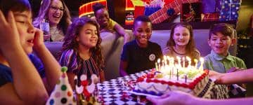 Andy B's hosts a birthday party with a cake and smiling children.